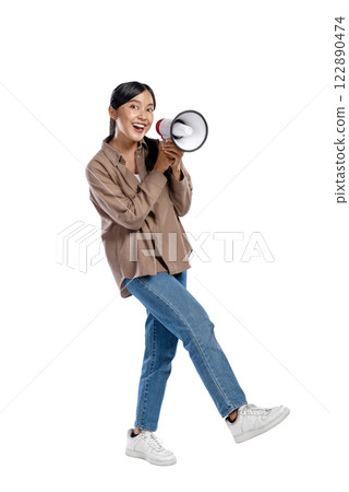 Portrait of an Asian Indonesian Woman in a shirt talking on a megaphone isolated over a white background. Concept of communication 122890474