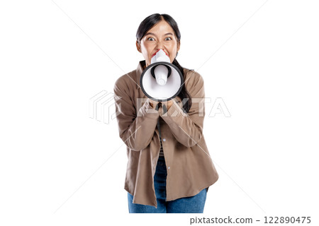 Portrait of an Asian Indonesian Woman in a shirt talking on a megaphone isolated over a white background. Concept of communication 122890475