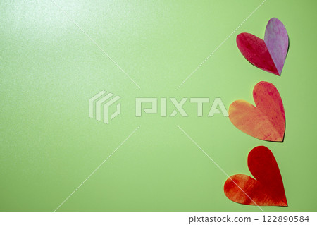 Red hearts on a colored background 122890584