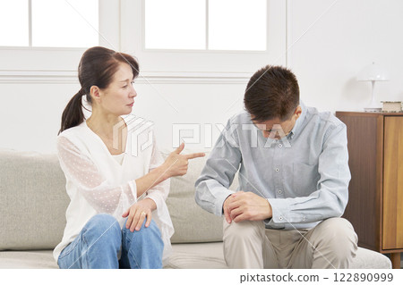 Wife scolding her husband, senior couple, living room 122890999