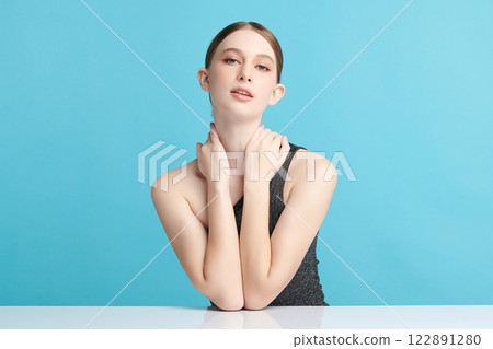 Beautiful young woman with clean fresh skin on blue background, Face care, Facial treatment, Cosmetology, beauty and spa, women portrait. 122891280