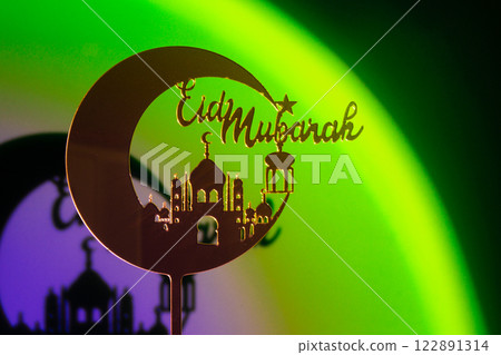 Crescent moon with mosque. Traditional Islamic holiday greetings Eid Mubarak. Ramadan Kareem concept background. Creative light and shadows sunset lamp lantern. Islamic holiday poster Eid-Ul-Adha Crescent moon with mosque. Traditional Islamic holiday greetings Eid Mubarak. Ramadan Kareem concept background. Creative light and shadows sunset lamp lantern. Islamic holiday poster Eid-Ul-Adha 122891314