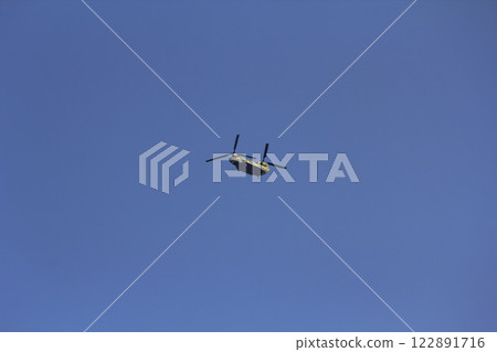 A large Self-Defense Force helicopter flying in the blue sky 122891716