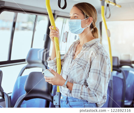 Covid, face mask and public transport with woman in a bus or train on commute into city or work during coronavirus pandemic. Travel, precaution and safety of commuter or passenger female traveling 122892316