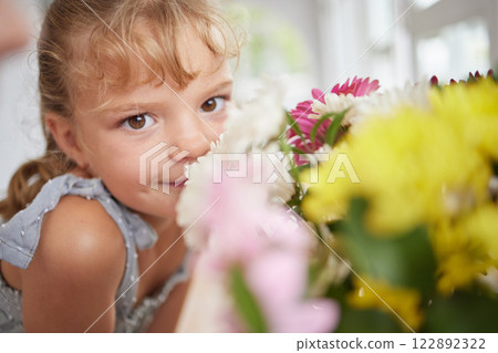 Flower smell and little girl in spring portrait with beautiful bouquet of fresh daisies aroma. Young child enjoying sweet and natural scent of bright floral garden petals in family home. Flower smell and little girl in spring portrait with beautiful bouquet of fresh daisies aroma. Young child enjoying sweet and natural scent of bright floral garden petals in family home. 122892322