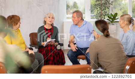 Senior female tutor leading educational class for elderly Senior female tutor leading educational class for elderly 122892701