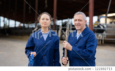 Portrait of man and woman positive cow farm workers Portrait of man and woman positive cow farm workers 122892713
