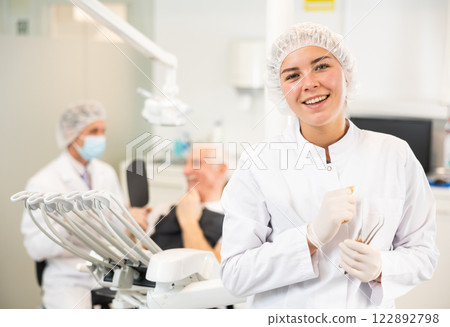 Young woman nurse is standing in dental office, clinic Young woman nurse is standing in dental office, clinic 122892798
