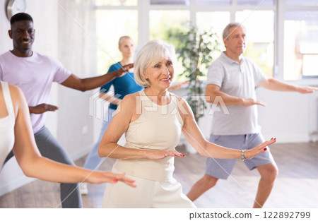 Group of multiethnic mature people dancing modern dance Group of multiethnic mature people dancing modern dance 122892799