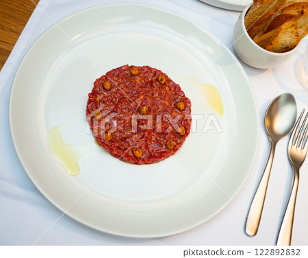 Exquisite French dish is veal tartare decorated with pickled capers Exquisite French dish is veal tartare decorated with pickled capers 122892832