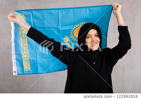 Young woman in hijab posing with flag of Kazakhstan Young woman in hijab posing with flag of Kazakhstan 122892858