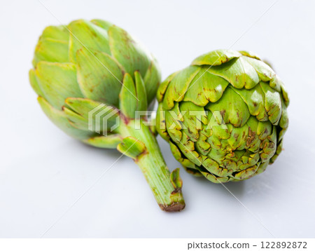 Closeup of ripe artichoke globes on white background Closeup of ripe artichoke globes on white background 122892872