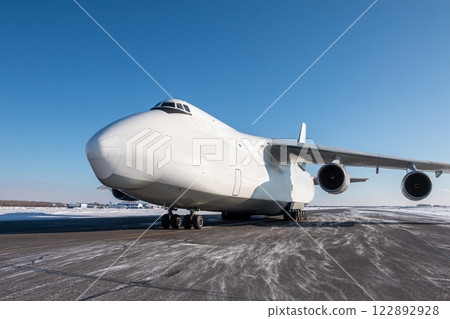 White wide body transport cargo aircraft at winter airport White wide body transport cargo aircraft at winter airport 122892928
