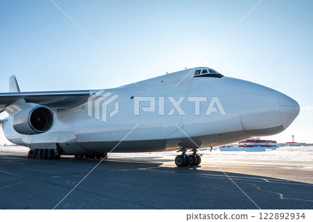 White wide body transport cargo airplane at winter airport White wide body transport cargo airplane at winter airport 122892934