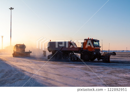 Snow removal trucks cleans airport in the evening at winter Snow removal trucks cleans airport in the evening at winter 122892951