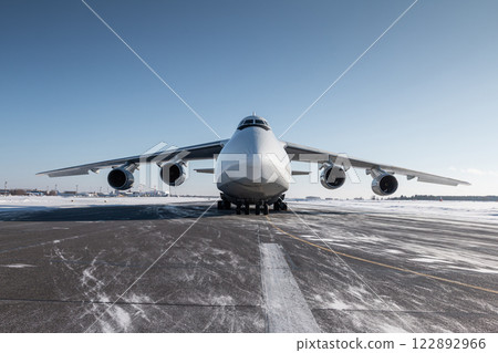 Front view of the white wide body transport cargo airplane at winter airport Front view of the white wide body transport cargo airplane at winter airport 122892966