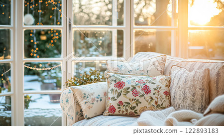 Colorful pillows on sofa against glass wall of window in a winter garden or conservatory. Interior textile concept. High quality photo 122893183