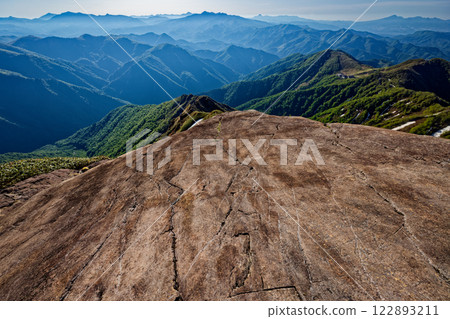View of Oze, Mount Hotaka, and Mount Akagi from a monolith on the former glacier of Mount Tanigawa's Nishikuro Ridge 122893211