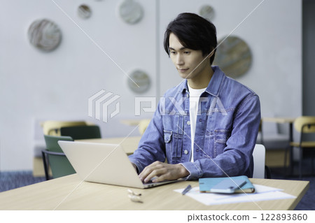 A young man using a laptop computer in an office cafe. Photo courtesy of Sky Perfect Tokyo Media Center A young man using a laptop computer in an office cafe. Photo courtesy of Sky Perfect Tokyo Media Center 122893860