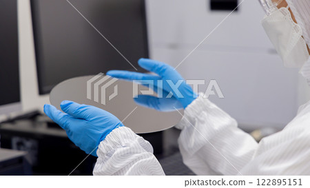 Engineer inspecting a silicon wafer Engineer inspecting a silicon wafer 122895151