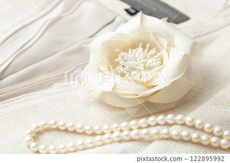 Flower corsage and pearl necklace 122895992