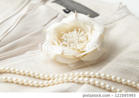 Flower corsage and pearl necklace 122895993