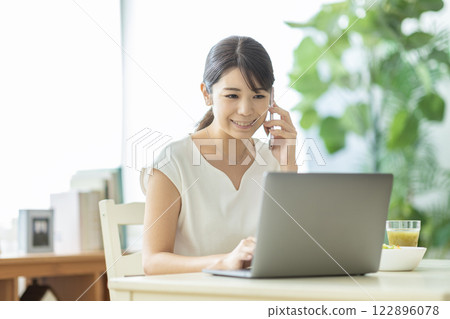 A woman making a phone call A woman making a phone call 122896078