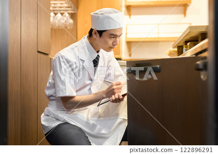 A Japanese chef managing inventory 122896291