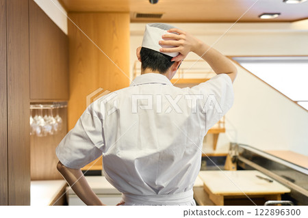 The back view of a worried Japanese chef 122896300