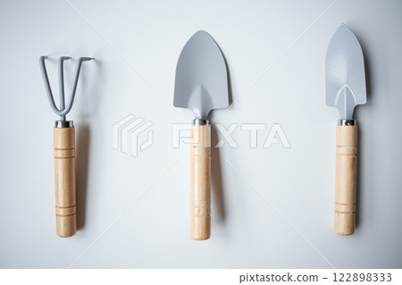 Set of three gardening tools with wooden handles on white background Set of three gardening tools with wooden handles on white background 122898333