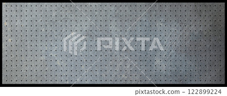 Old metal pegboard background texture 122899224