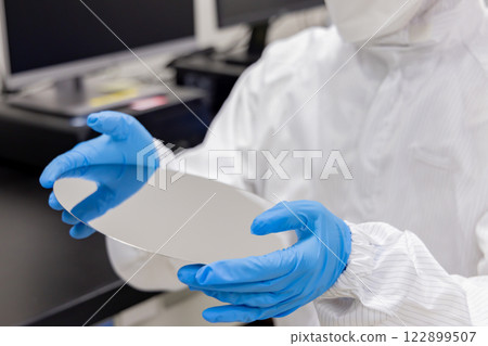 Engineer inspecting a silicon wafer 122899507
