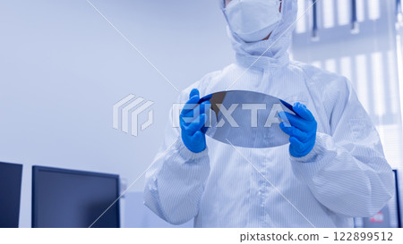 Engineer inspecting a silicon wafer Engineer inspecting a silicon wafer 122899512