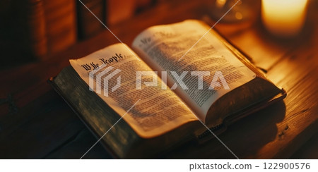 Open antique book showing we the people illuminated by candlelight, celebrating president's day 122900576