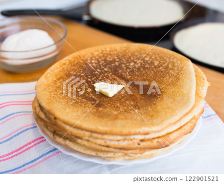 Cooking traditional pancakes from wheat flour in the kitchen Cooking traditional pancakes from wheat flour in the kitchen 122901521