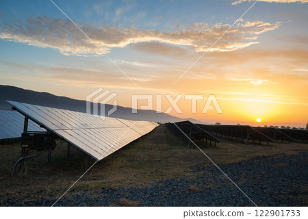 Sunset at Solar power station. Solar panels, photovoltaics, alternative source of electricity - concept of sustainable and renewable sources. Sunset at Solar power station. Solar panels, photovoltaics, alternative source of electricity - concept of sustainable and renewable sources. 122901733