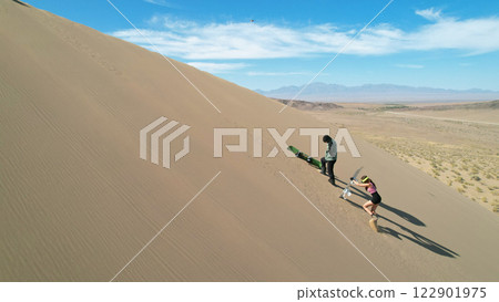 Sandboarding on the dunes of the lut desert, kerman, iran Sandboarding on the dunes of the lut desert, kerman, iran 122901975