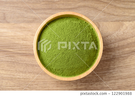 Matcha green tea powder in bowl on wooden background, Table top view 122901988