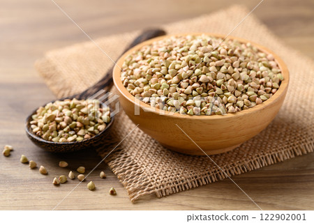 Organic buckwheat seed in wooden bowl with spoon, Food ingredient Organic buckwheat seed in wooden bowl with spoon, Food ingredient 122902001