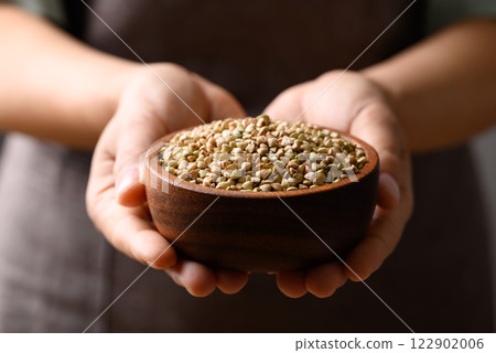 Organic buckwheat seed in wooden bowl holding by hand, Food ingredient Organic buckwheat seed in wooden bowl holding by hand, Food ingredient 122902006