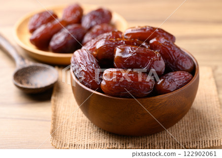 Date palm fruit (MedJool) in wooden bowl 122902061
