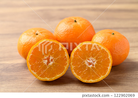 Mandarin tangerine orange fruit on wooden background Mandarin tangerine orange fruit on wooden background 122902069