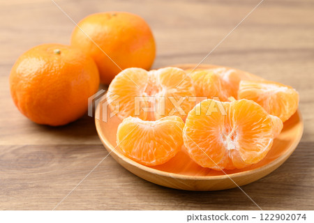 Mandarin tangerine orange fruit on wooden plate ready to eating Mandarin tangerine orange fruit on wooden plate ready to eating 122902074