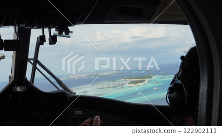 Pilots flying over tropical islands in the maldives 122902111