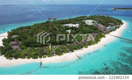 Tropical island resort in maldives embraces tranquil luxury and pristine beaches 122902134