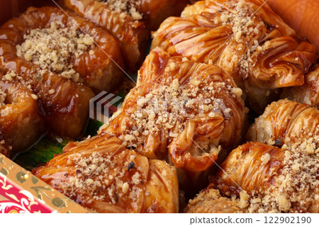 Delicious baklava dessert served on a platter at a festive gathering in a traditional setting Delicious baklava dessert served on a platter at a festive gathering in a traditional setting 122902190