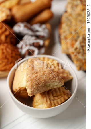 Delicious assortment of pastries and treats displayed in a bowl and on a table 122902241