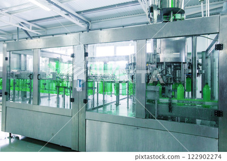 Bottle filling machinery in a modern production facility at midday 122902274