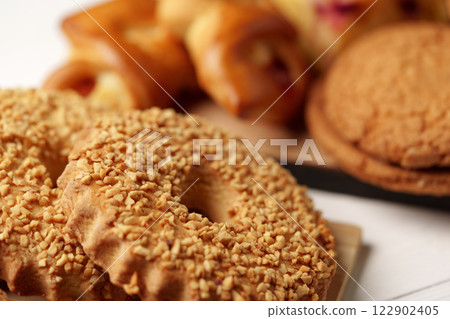 Delicious assortment of baked goods featuring nutty cookies and flaky pastries on display Delicious assortment of baked goods featuring nutty cookies and flaky pastries on display 122902405