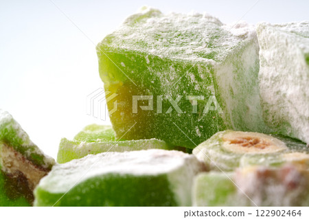 Delightful green sweets displayed with a light dusting of powdered sugar, emphasizing their unique texture and flavor 122902464